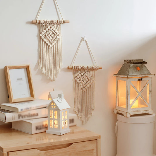 Decorative wall hangings and lanterns on a wooden surface with a soft light.