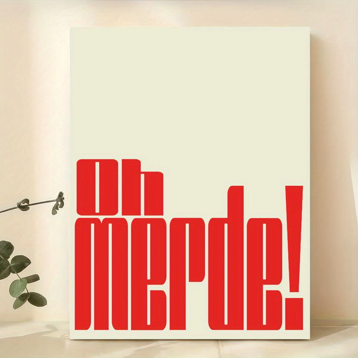 Canvas with red text 'Oh merde!' on a light background with a plant.